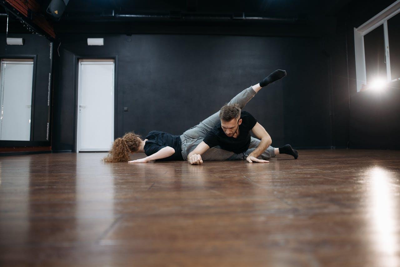 Mastering the First Impression: Your intriguing post title goes here Male and female dancers performing a contemporary routine on a wooden floor in a studio.